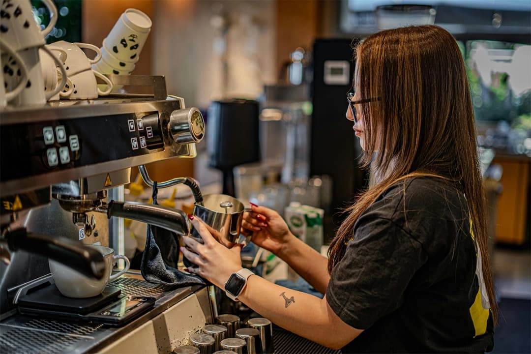Barista making coffee at a UK cafe
